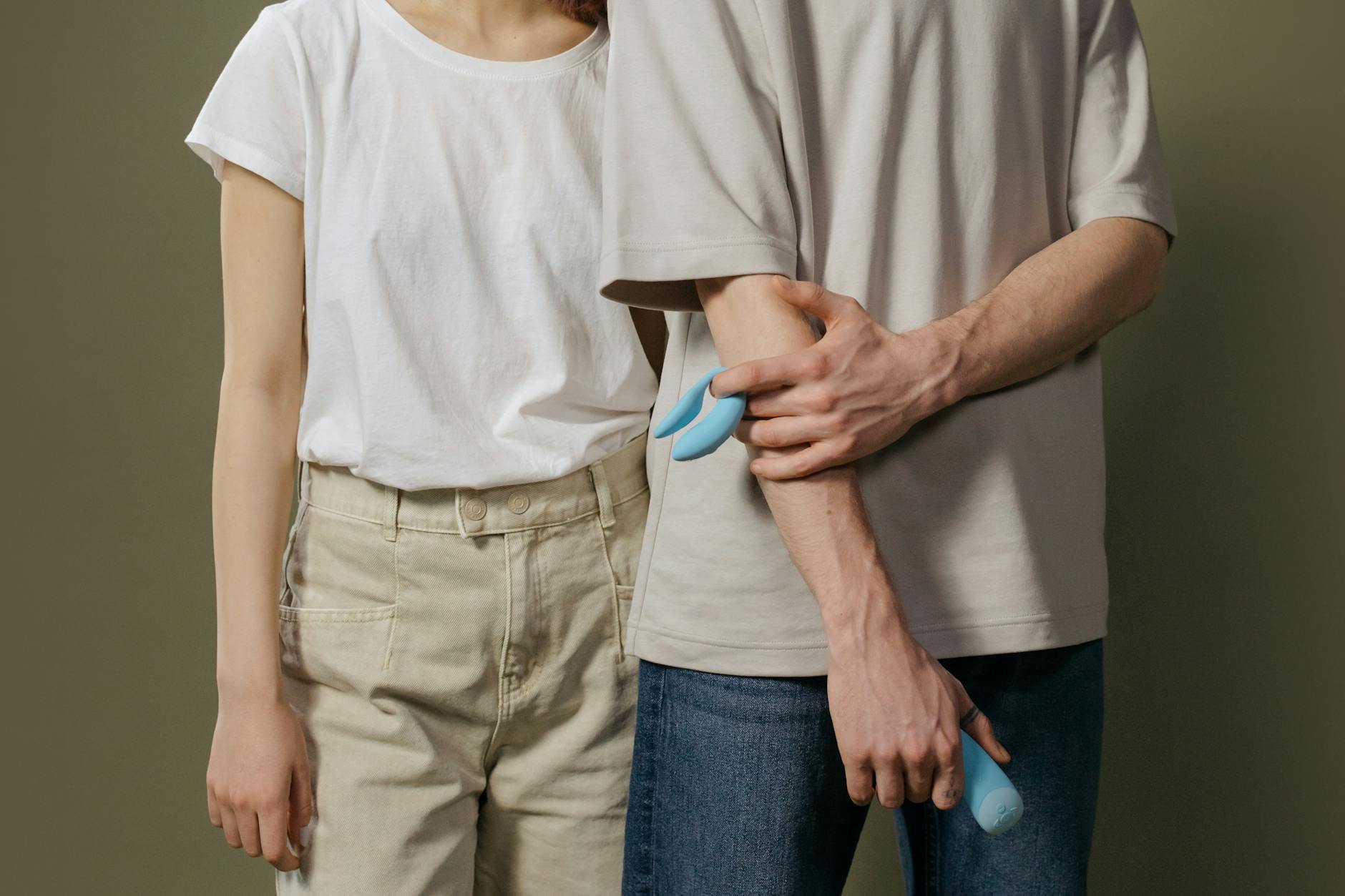 Couple holding a vibrator together indoors, symbolizing shared intimacy and reconnection