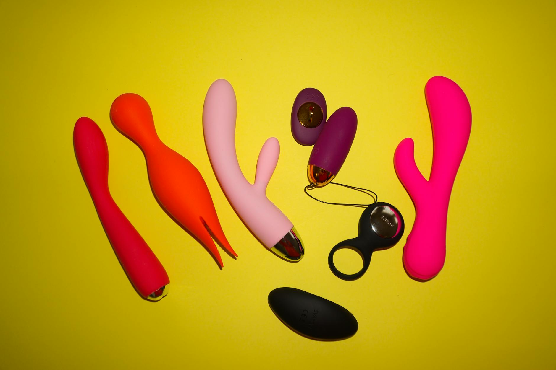 Hands holding a sleek blue clitoral vibrator, representing reclaiming pleasure and control